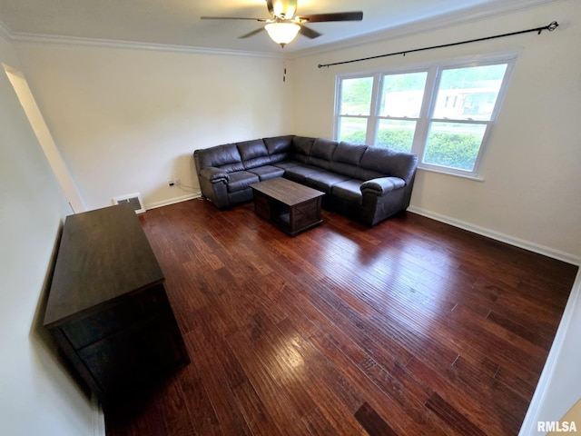living area with a ceiling fan, visible vents, wood finished floors, baseboards, and ornamental molding