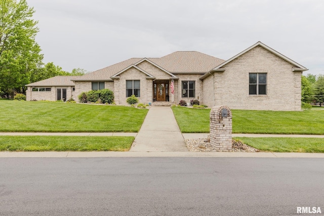 single story home with brick siding and a front yard