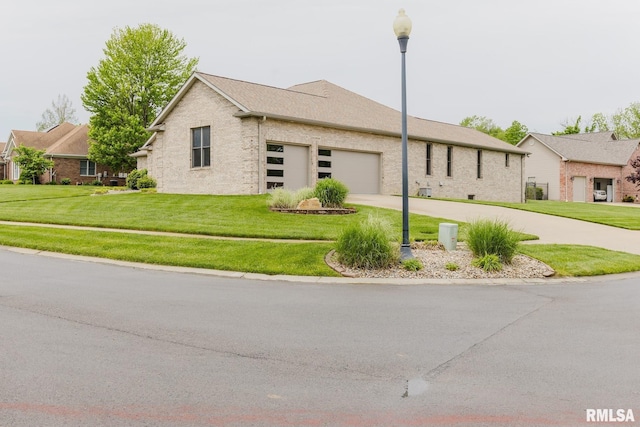 ranch-style house with a garage, driveway, brick siding, and a front yard