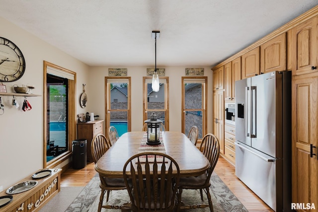 dining area featuring light wood finished floors
