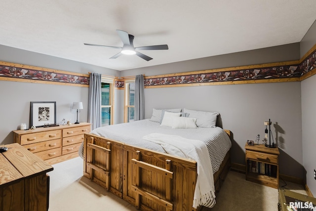 bedroom featuring a ceiling fan and light carpet