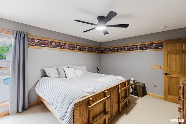 bedroom with baseboards, ceiling fan, and light carpet