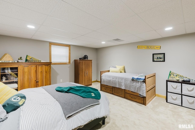 bedroom featuring baseboards, recessed lighting, a drop ceiling, and light carpet