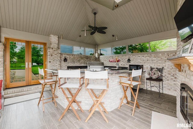 view of patio / terrace with french doors, outdoor wet bar, a grill, and exterior kitchen
