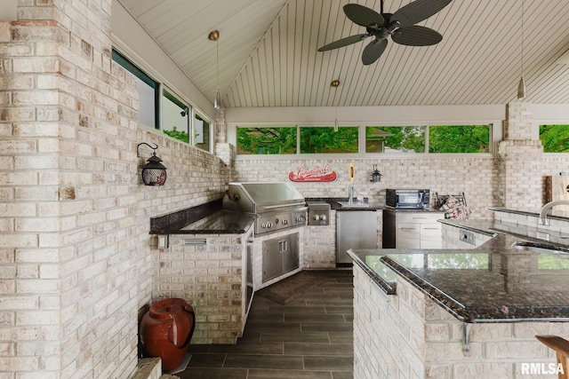 view of patio with an outdoor kitchen, a sink, a ceiling fan, and a grill