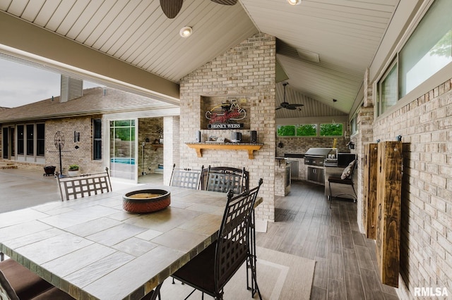 view of patio / terrace featuring outdoor dining area, a ceiling fan, grilling area, and an outdoor kitchen