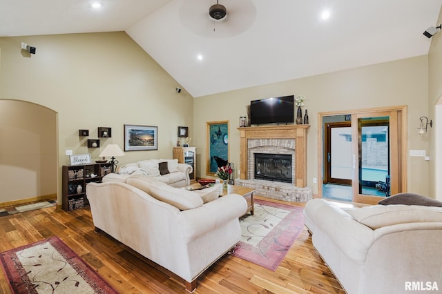 living area with a brick fireplace, wood finished floors, ceiling fan, high vaulted ceiling, and recessed lighting