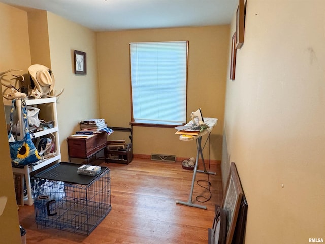 miscellaneous room featuring visible vents and wood finished floors