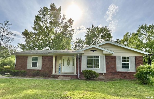 ranch-style house with brick siding and a front lawn