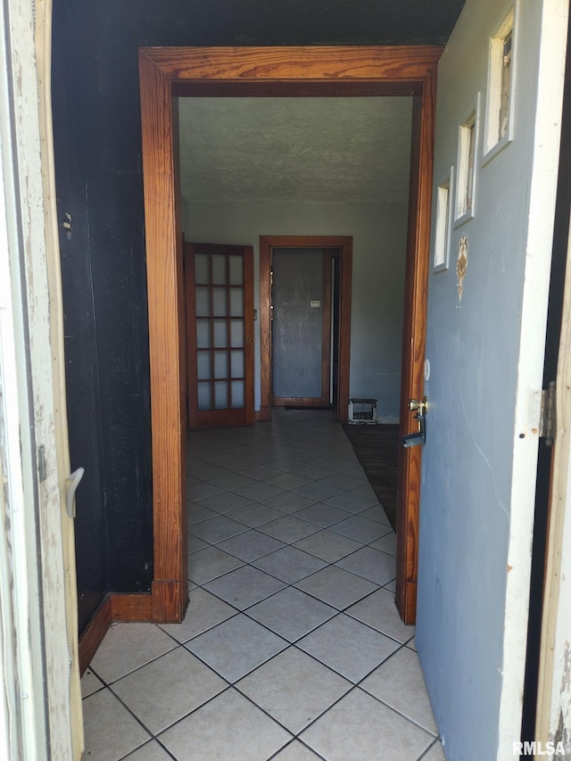 corridor featuring light tile patterned floors