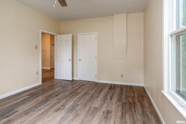 2016 Division St, Murphysboro, IL 62966 - unfurnished bedroom with baseboards, multiple windows, and wood finished floors