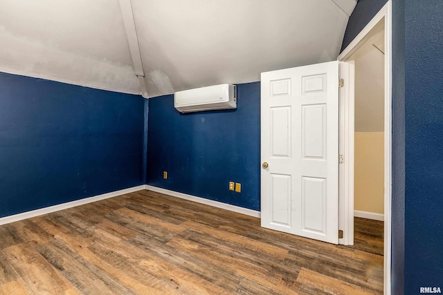 2016 Division St, Murphysboro, IL 62966 - unfurnished room featuring vaulted ceiling, wood finished floors, baseboards, and a wall mounted AC