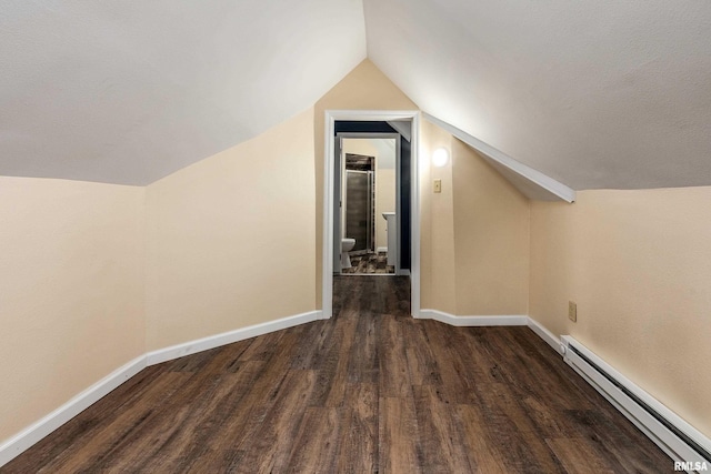 2016 Division St, Murphysboro, IL 62966 - bonus room with baseboards, lofted ceiling, a baseboard radiator, and dark wood-style floors