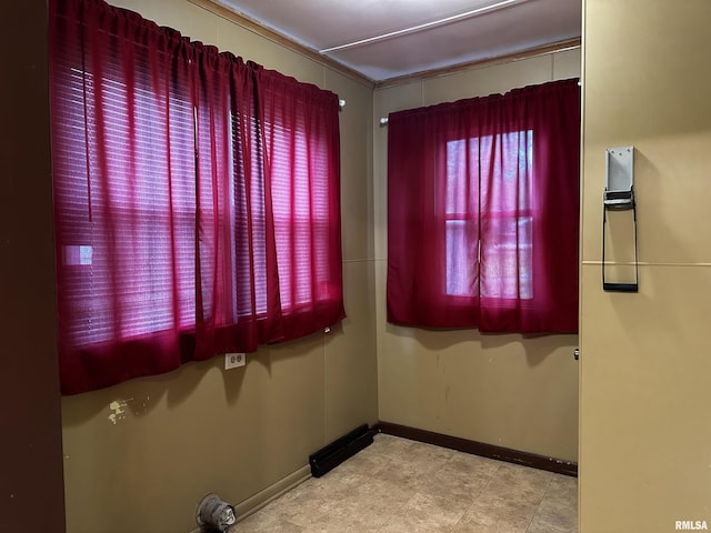 spare room with baseboards