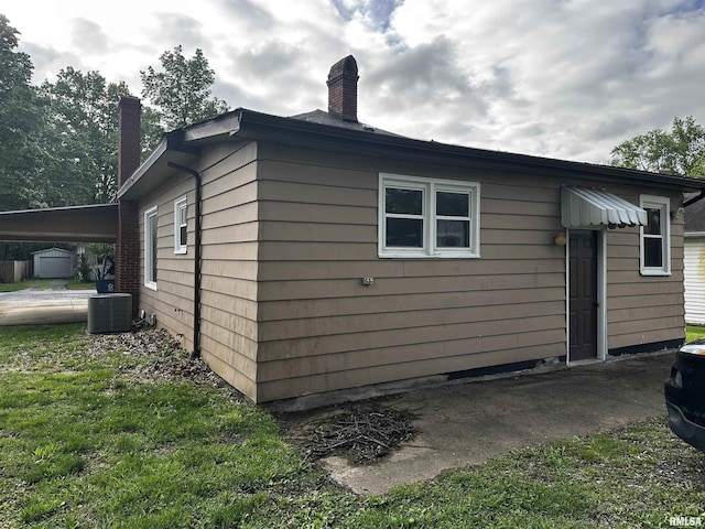 view of property exterior featuring a chimney and central AC unit