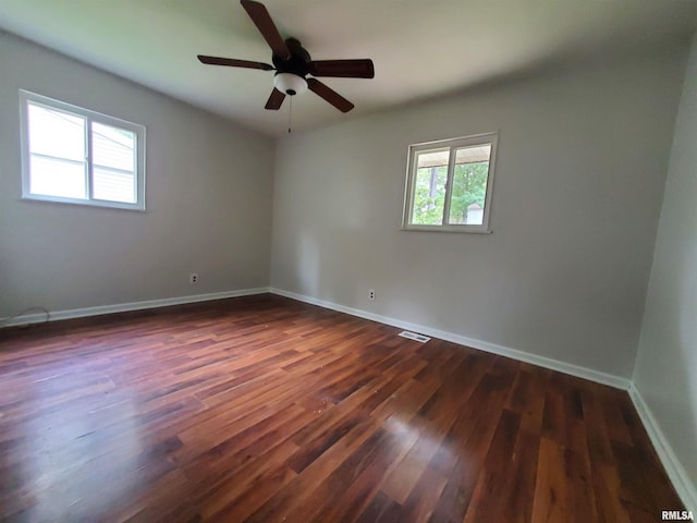 1027 W Laurel St, Carbondale, IL 62901 - unfurnished room with baseboards, ceiling fan, visible vents, and dark wood finished floors