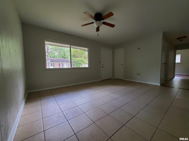 1027 W Laurel St, Carbondale, IL 62901 - spare room featuring a ceiling fan, baseboards, light tile patterned floors, and visible vents