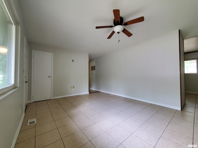 1027 W Laurel St, Carbondale, IL 62901 - empty room with light tile patterned floors, visible vents, baseboards, and ceiling fan