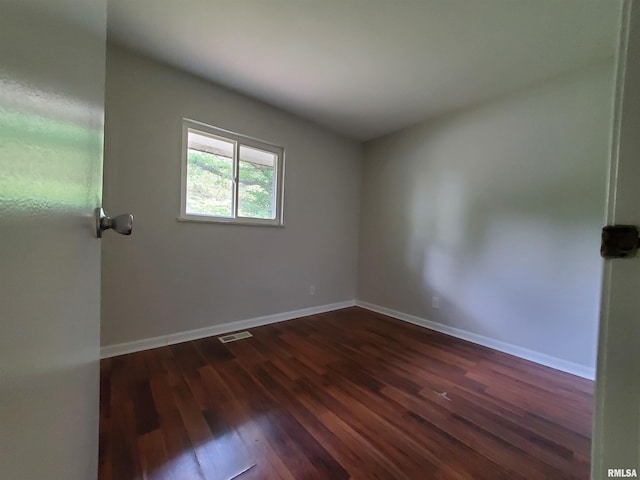 1027 W Laurel St, Carbondale, IL 62901 - spare room featuring baseboards, dark wood-style flooring, and visible vents