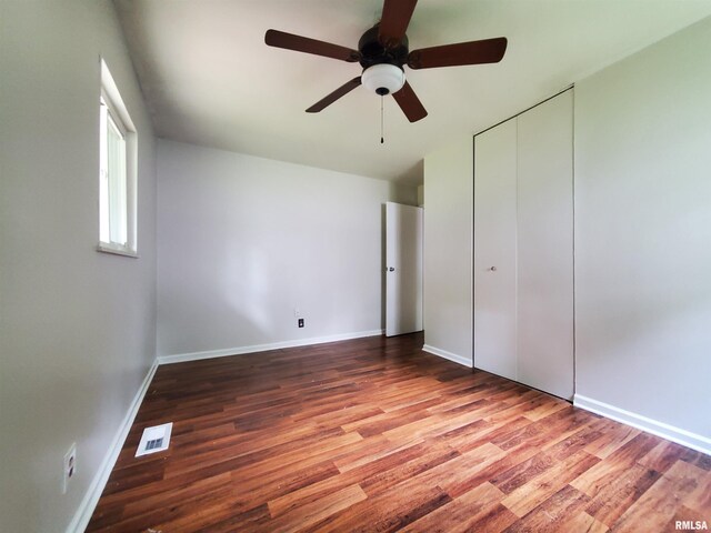 1027 W Laurel St, Carbondale, IL 62901 - unfurnished bedroom with baseboards, visible vents, and wood finished floors