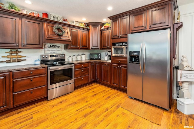 24 Karen Dr, Christopher, IL 62822 - kitchen featuring a toaster, stainless steel appliances, light wood-style floors, decorative backsplash, and recessed lighting