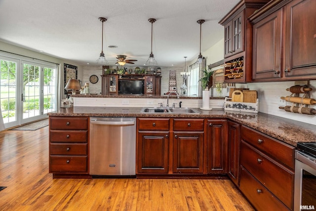 24 Karen Dr, Christopher, IL 62822 - kitchen featuring a peninsula, appliances with stainless steel finishes, decorative light fixtures, and a sink