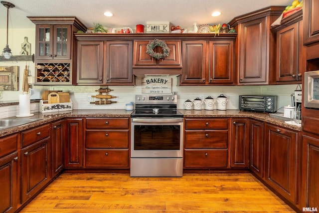 24 Karen Dr, Christopher, IL 62822 - kitchen with stainless steel range with electric stovetop, a toaster, tasteful backsplash, and light wood-type flooring