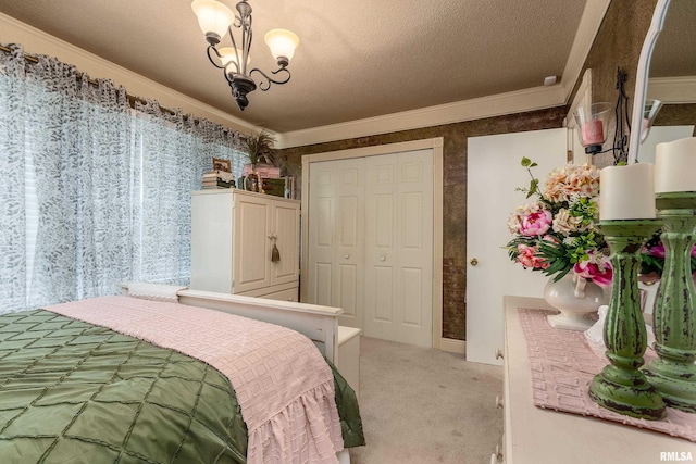 24 Karen Dr, Christopher, IL 62822 - bedroom with a closet, a textured ceiling, ornamental molding, an inviting chandelier, and light carpet
