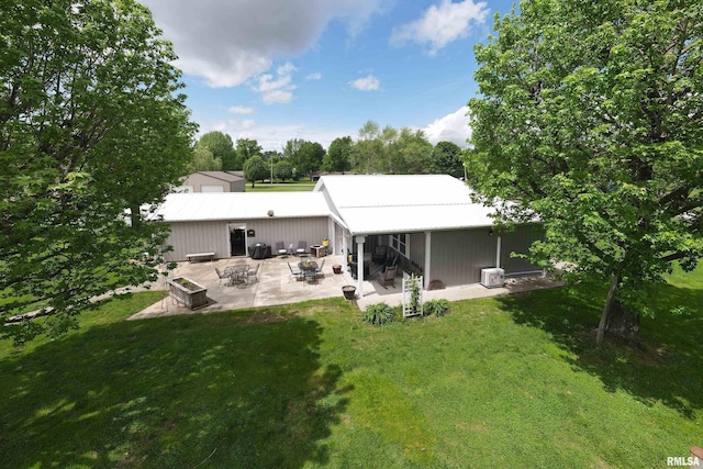 24 Karen Dr, Christopher, IL 62822 - rear view of property with a patio, metal roof, and a lawn