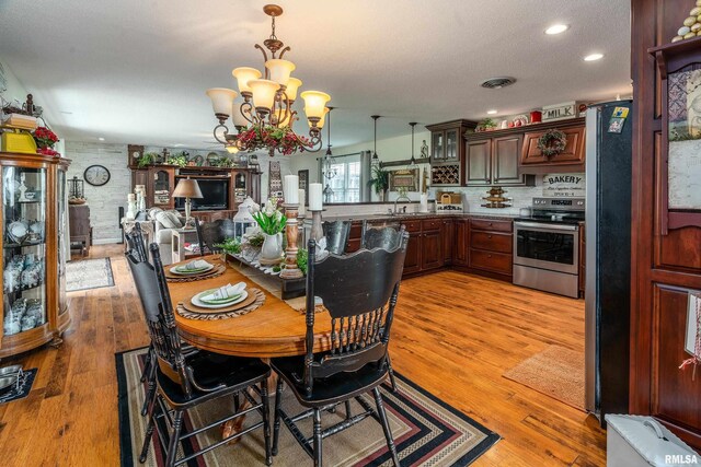 24 Karen Dr, Christopher, IL 62822 - dining space featuring a chandelier, recessed lighting, a textured ceiling, and light wood-style floors