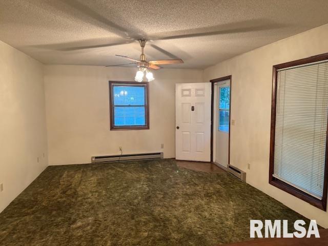 unfurnished room featuring a baseboard heating unit, a textured ceiling, carpet, ceiling fan, and baseboard heating
