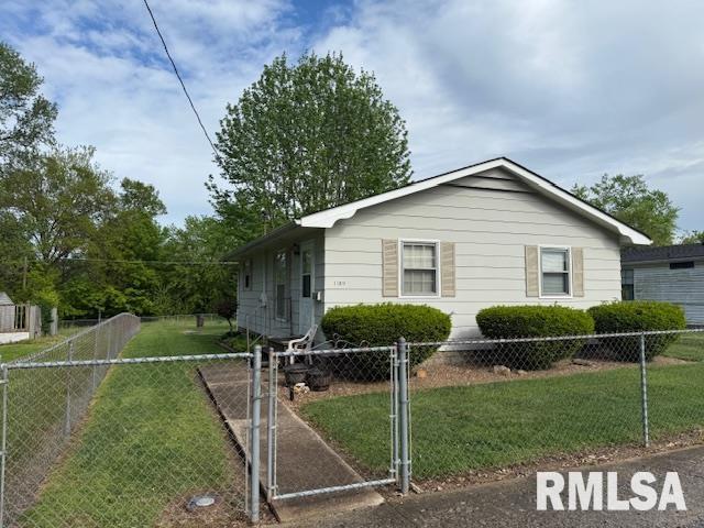 view of front of property featuring a gate, fence private yard, and a front lawn