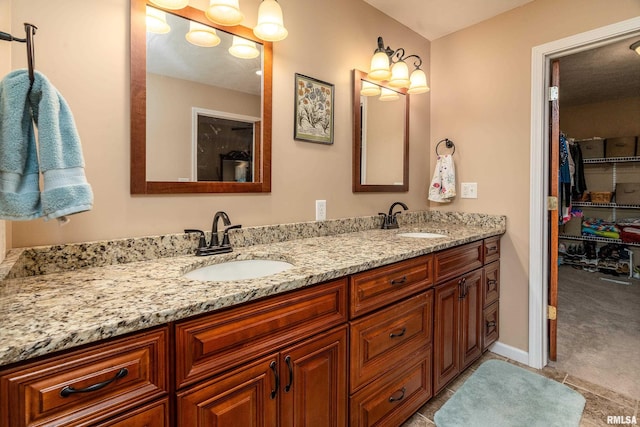 bathroom with tile patterned floors, double vanity, and a sink