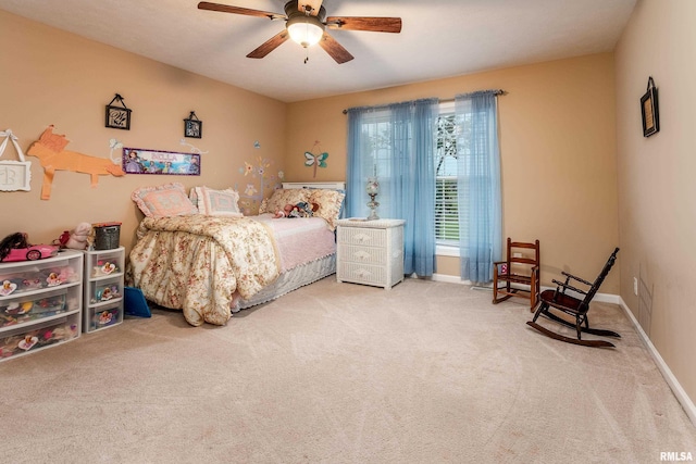 carpeted bedroom featuring baseboards and a ceiling fan