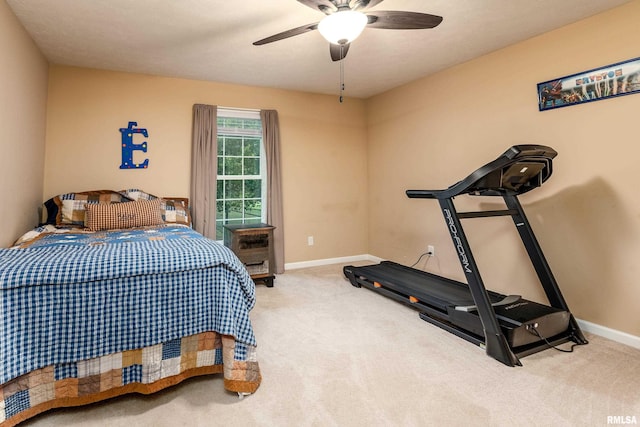 carpeted bedroom featuring baseboards and ceiling fan