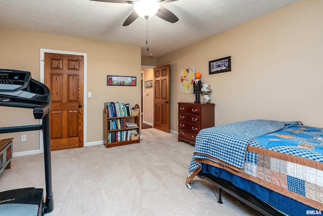 bedroom featuring baseboards, light carpet, and a ceiling fan