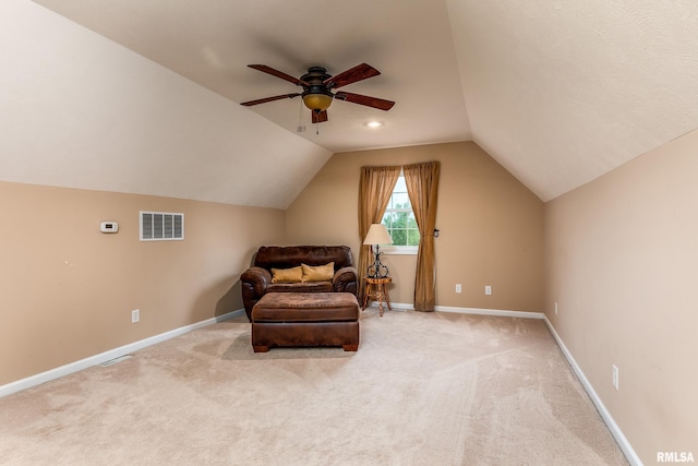 living area featuring ceiling fan, lofted ceiling, carpet, and visible vents