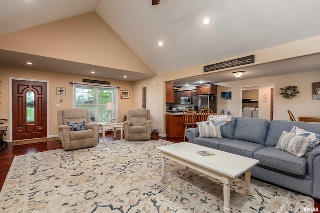 living room featuring recessed lighting, baseboards, high vaulted ceiling, wood finished floors, and washer and clothes dryer