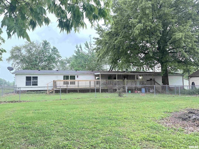 rear view of house featuring a fenced backyard and a yard