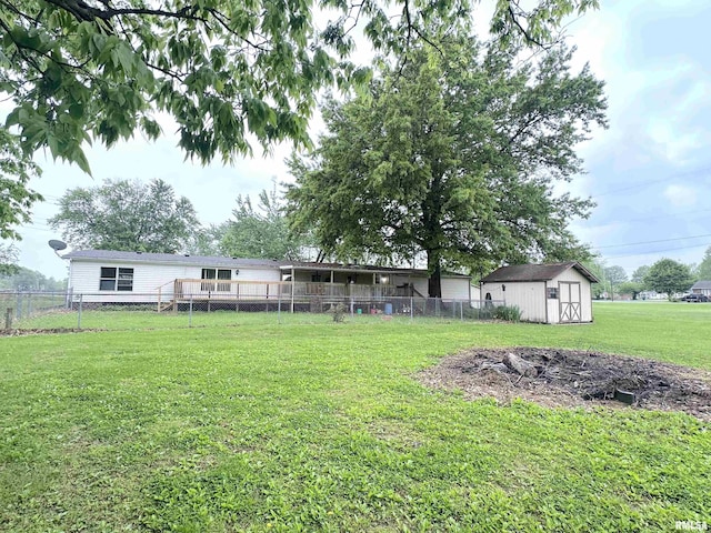 view of yard featuring an outbuilding, fence, and a storage unit