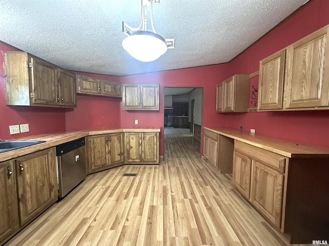 kitchen with light countertops, light wood-style flooring, a textured ceiling, visible vents, and dishwasher