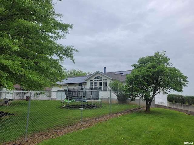 325 W N St, Dix, IL 62830 - rear view of house with a yard, fence private yard, and solar panels