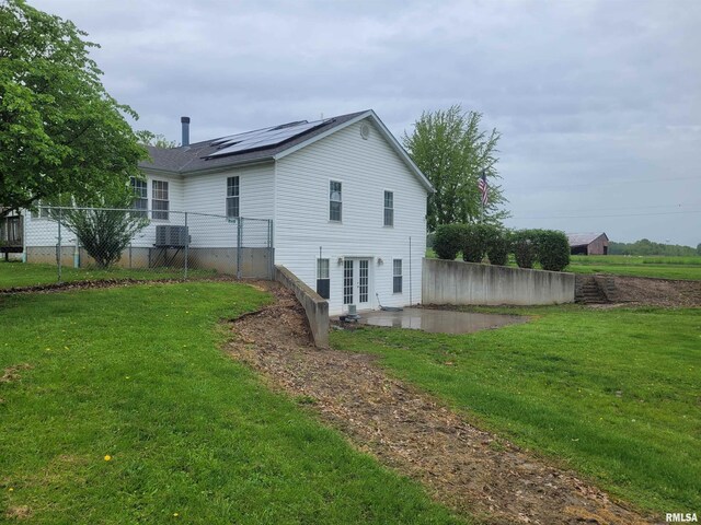 325 W N St, Dix, IL 62830 - back of property with a lawn, a patio, french doors, and solar panels