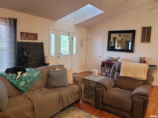 325 W N St, Dix, IL 62830 - living room featuring a wealth of natural light, visible vents, vaulted ceiling with skylight, and wood finished floors