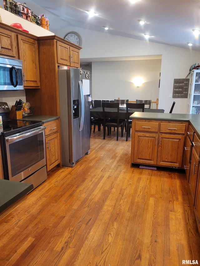 325 W N St, Dix, IL 62830 - kitchen with brown cabinetry, light wood finished floors, dark countertops, and stainless steel appliances