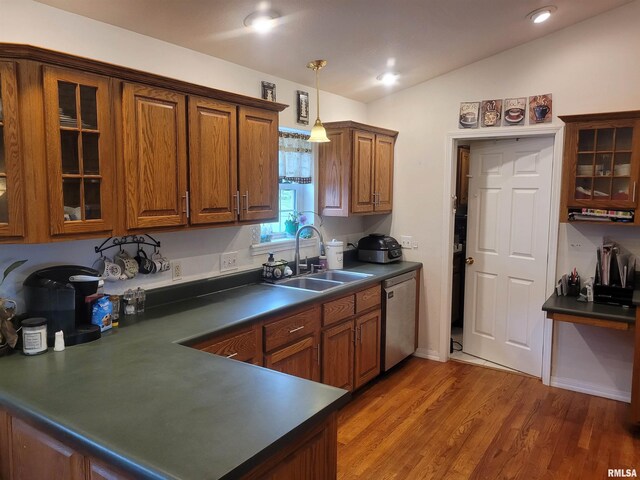 325 W N St, Dix, IL 62830 - kitchen with lofted ceiling, dishwasher, brown cabinetry, a sink, and dark countertops
