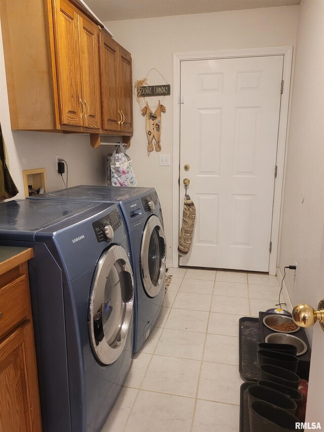 325 W N St, Dix, IL 62830 - clothes washing area with light tile patterned floors, washing machine and clothes dryer, and cabinet space