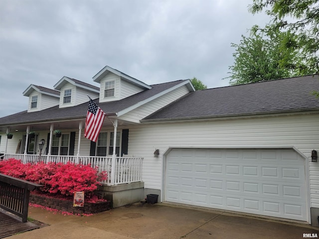 325 W N St, Dix, IL 62830 - cape cod home with a porch, roof with shingles, an attached garage, and driveway