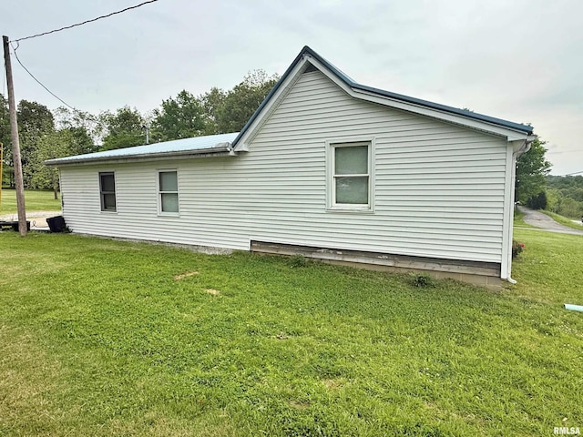 85 W State Highway 146, Golconda, IL 62938 - view of property exterior with a yard and metal roof