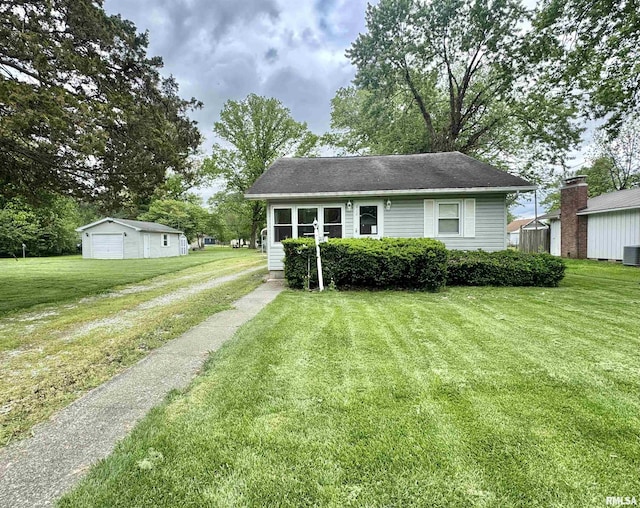612 W Reed St, Benton, IL 62812 - view of front facade featuring a front lawn, cooling unit, an outdoor structure, and a garage